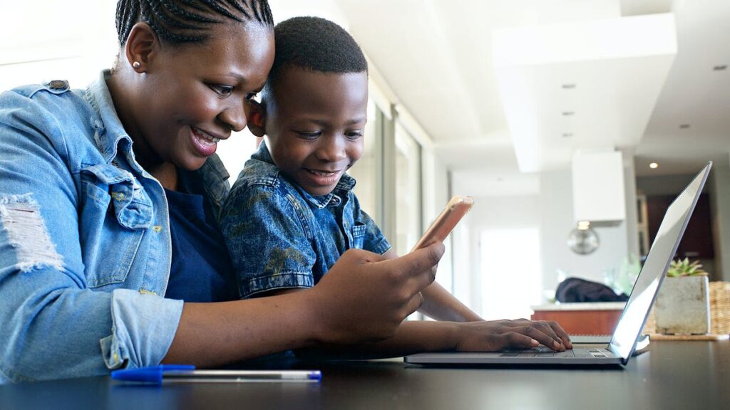 mother and son using smartphone at home for learning
